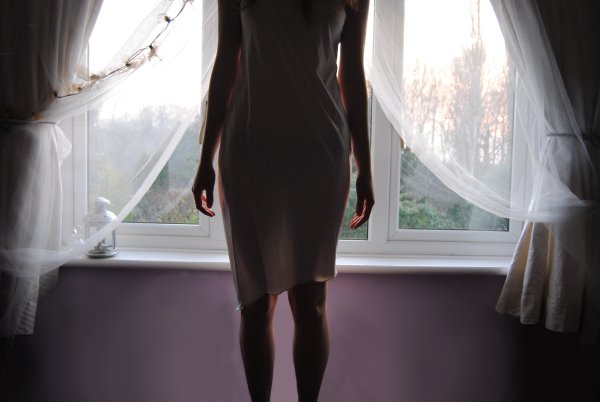 Девушка в платье у окна
