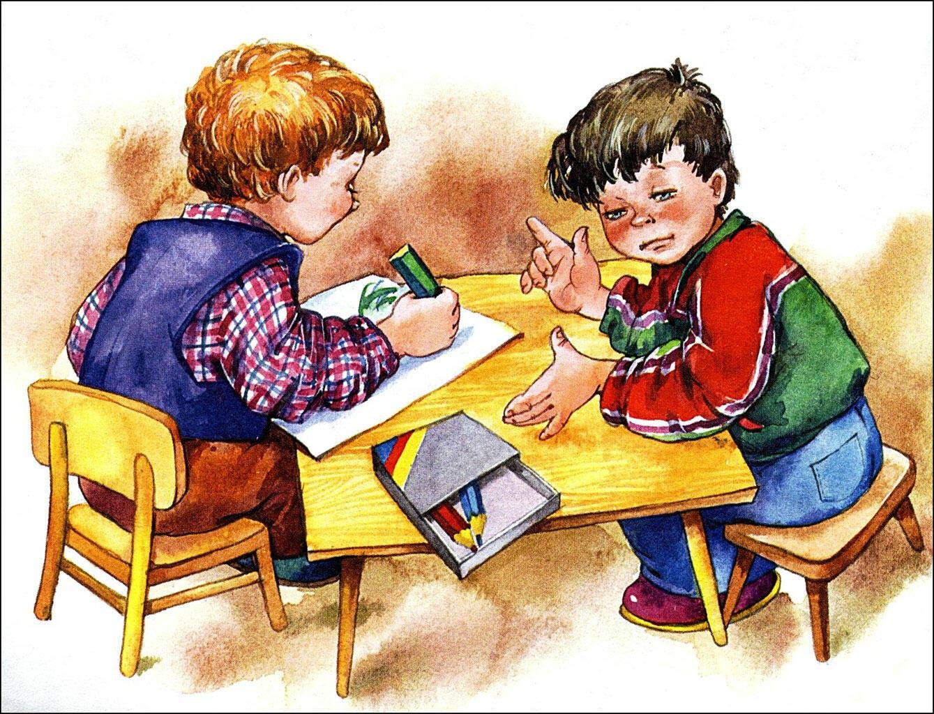 Ребенок рисует за столом