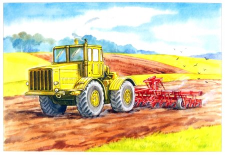 Трактор пашет землю